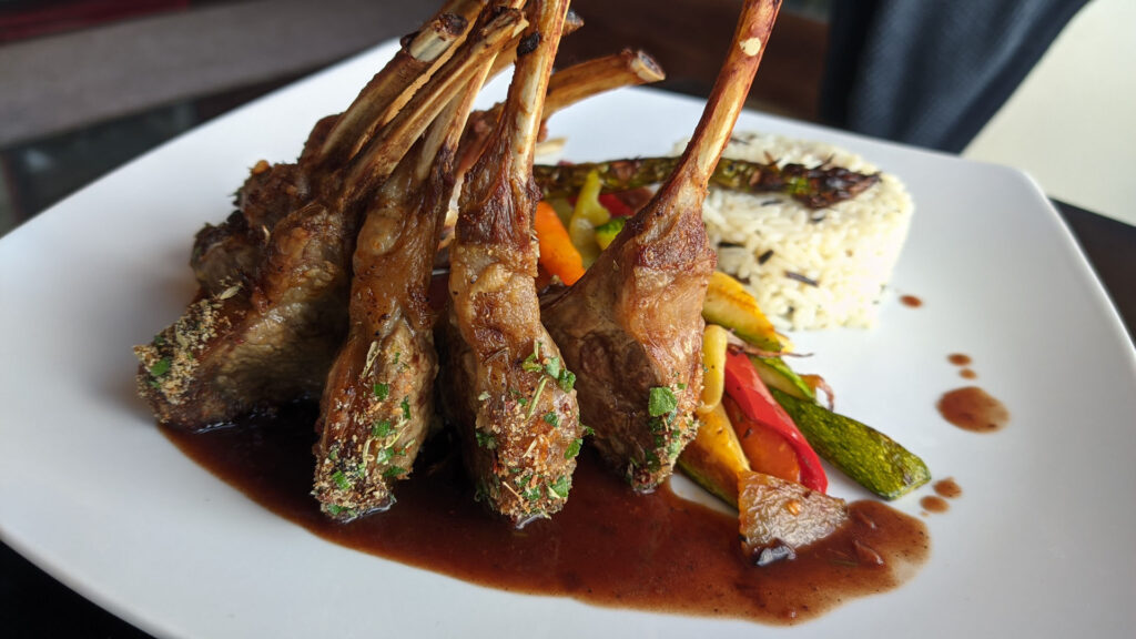 Nisos Restaurant Corfu lamb chops and rice dish with roasted vegetables